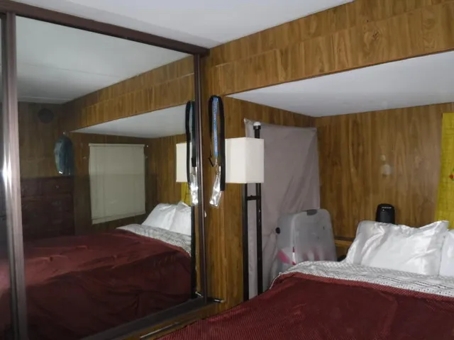 a bedroom with a bed and a mirror