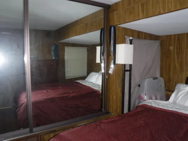 a bedroom with a bed and a mirror