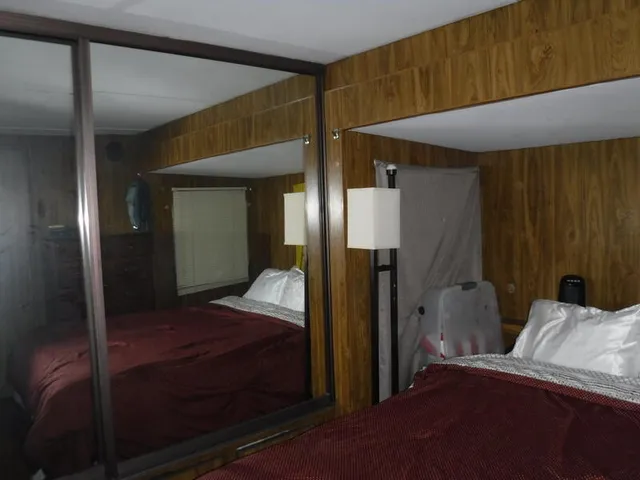 a bedroom with a bed and a mirror