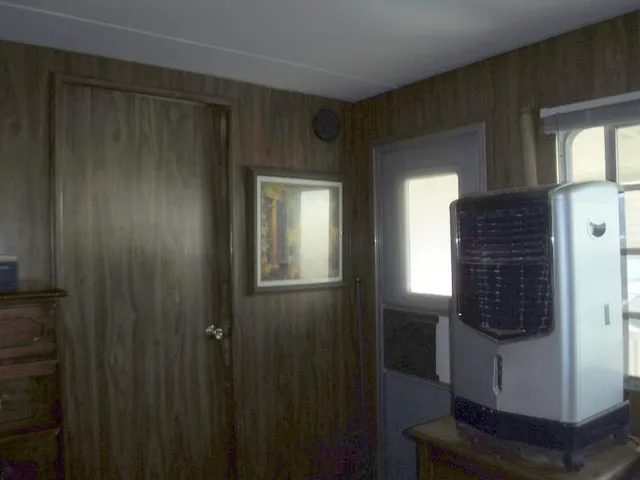 a hallway with front door wooden floor and windows