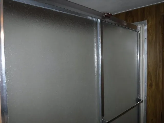 a bathroom with a toilet and a shower curtain