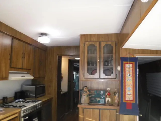 a kitchen with stainless steel appliances granite countertop a refrigerator and a stove