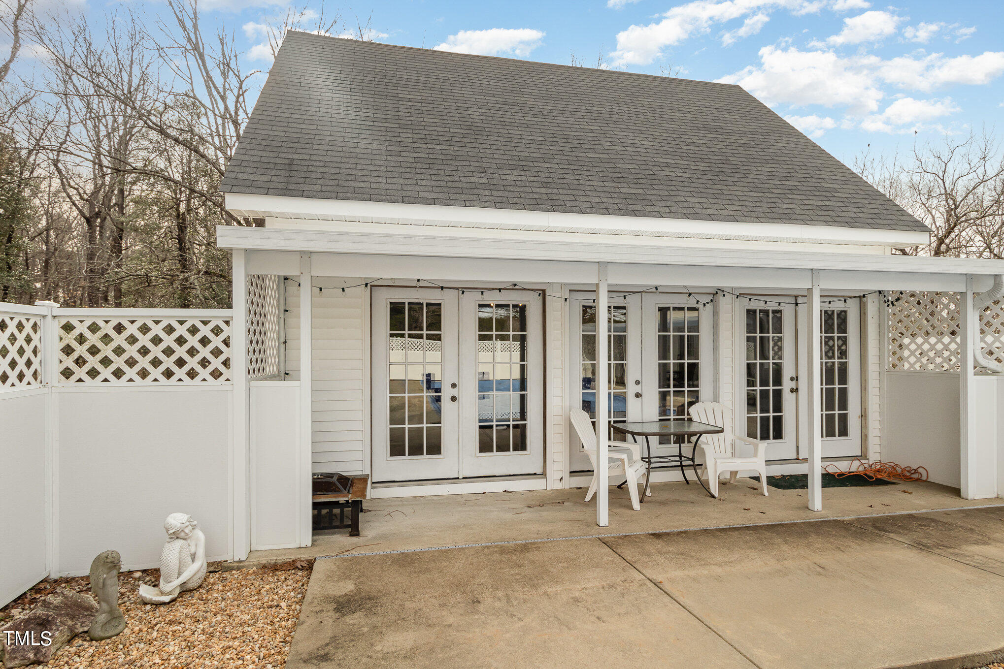 804 Bahama Road Bahama, NC 27503 - Photo 11 of 80 a patio with a table and chairs and potted plants