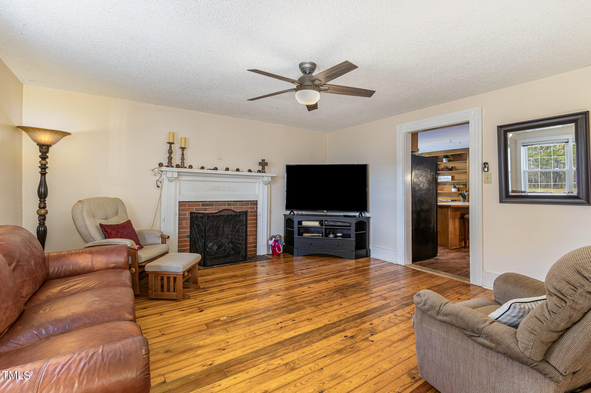 804 Bahama Road Bahama, NC 27503 - Photo 18 of 80 a living room with furniture a flat screen tv and a fireplace