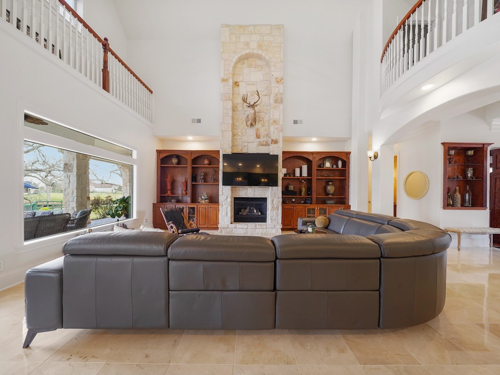 32134 Fulbrook Commons Fulshear, TX 77441 - Photo 16 of 49 The grand living space is both captivating and welcoming, anchored by soaring ceilings, architectural detail, and expansive views of the outdoor retreat. A refined yet comfortable setting designed for both intimate evenings and large gatherings.