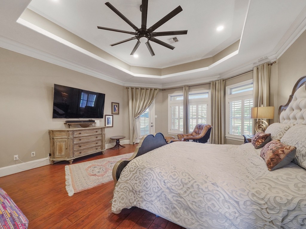 32134 Fulbrook Commons Fulshear, TX 77441 - Photo 19 of 49 Designed for seamless indoor-outdoor living, the primary suite features direct access to the backyard oasis — allowing tranquil mornings or evening swims just steps from your retreat.