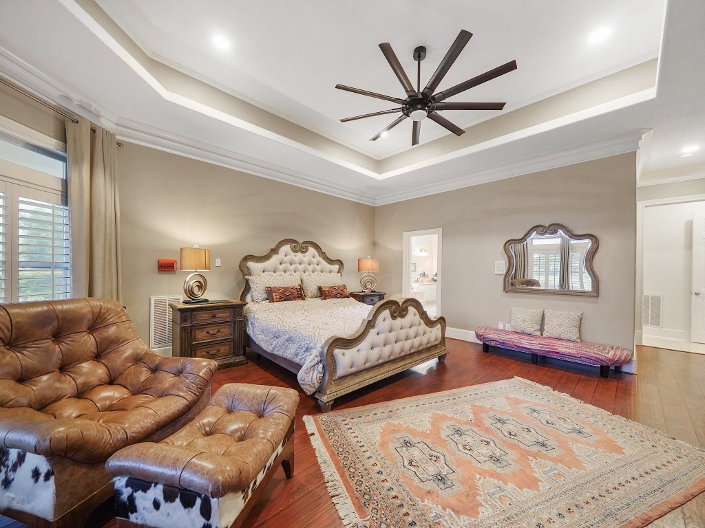 32134 Fulbrook Commons Fulshear, TX 77441 - Photo 20 of 49 A spacious and thoughtfully designed layout provides room for a private sitting area within the primary suite, blending comfort and sophistication beneath detailed ceiling architecture.