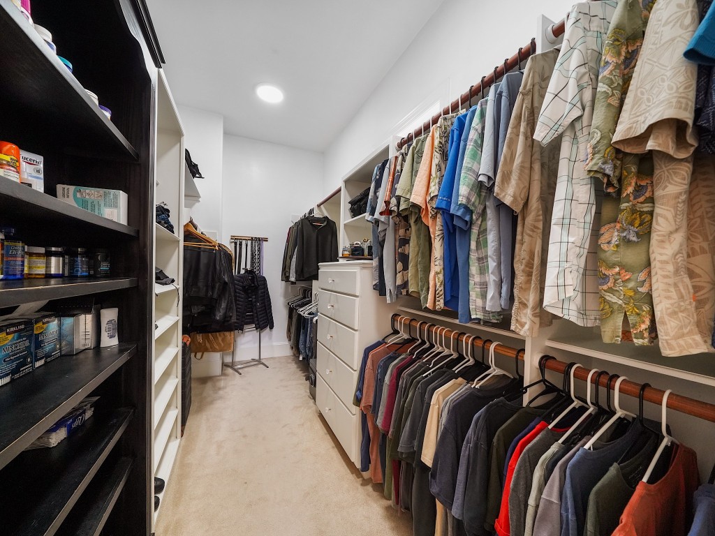 32134 Fulbrook Commons Fulshear, TX 77441 - Photo 24 of 49 The second walk-in closet provides additional custom storage space, ensuring both style and practicality within the primary retreat.
