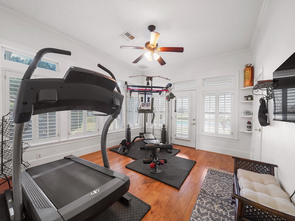 32134 Fulbrook Commons Fulshear, TX 77441 - Photo 25 of 49 Currently utilized as a fitness space, this versatile downstairs bedroom offers flexibility for guests, multigenerational living, or a private studio.