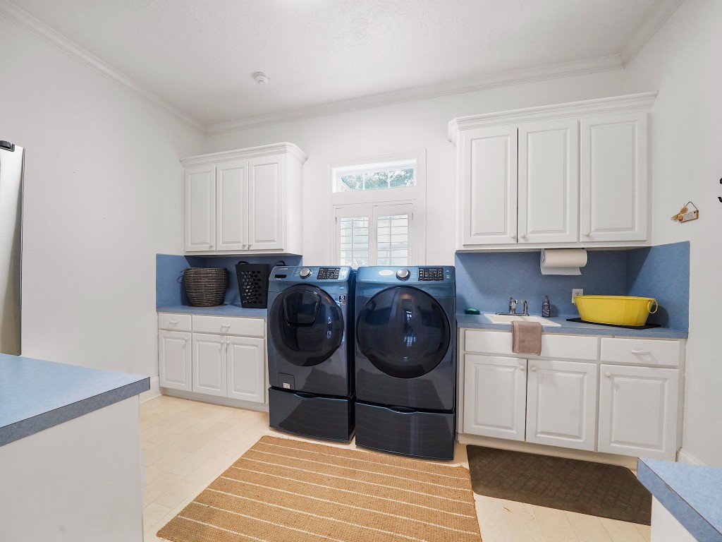 32134 Fulbrook Commons Fulshear, TX 77441 - Photo 27 of 49 The oversized utility room offers abundant cabinetry and workspace, thoughtfully designed to combine efficiency with organization.
