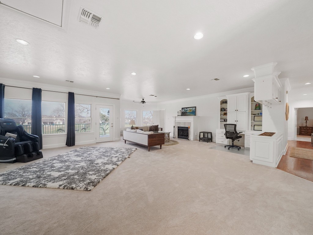 32134 Fulbrook Commons Fulshear, TX 77441 - Photo 29 of 49 An expansive upstairs game room offers endless possibilities for recreation, media, or additional living space, all while maintaining open sightlines and natural light.fireplace, wet bar, an d access to the balcony overlooking the backyard.