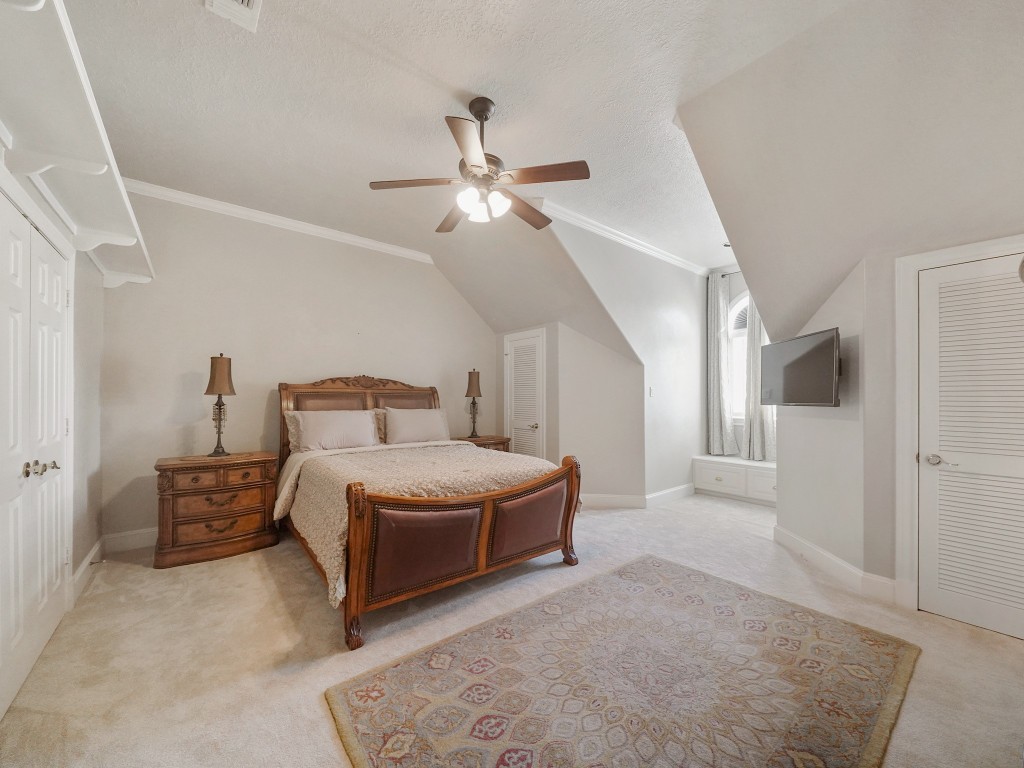 32134 Fulbrook Commons Fulshear, TX 77441 - Photo 32 of 49 This spacious upstairs bedroom features architectural ceiling lines and generous proportions, creating a comfortable and private retreat for family or guests.