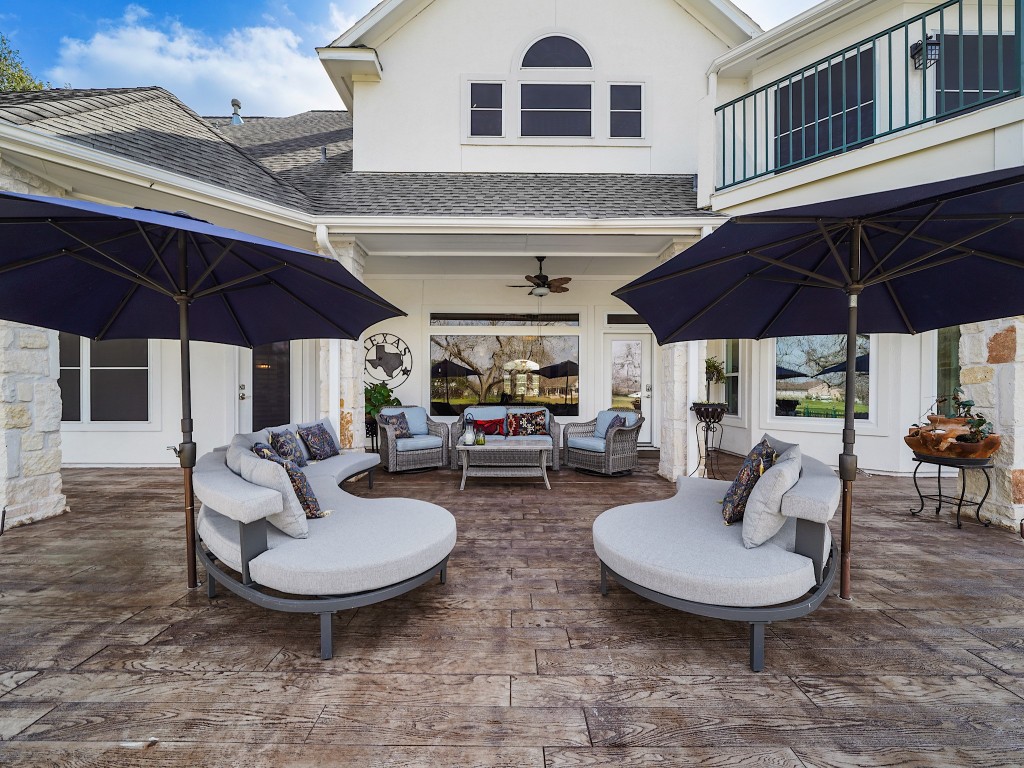 32134 Fulbrook Commons Fulshear, TX 77441 - Photo 41 of 49 The oversized covered patio creates an outdoor living room atmosphere, allowing ample space for seating and shaded comfort — ideal for year-round entertaining.