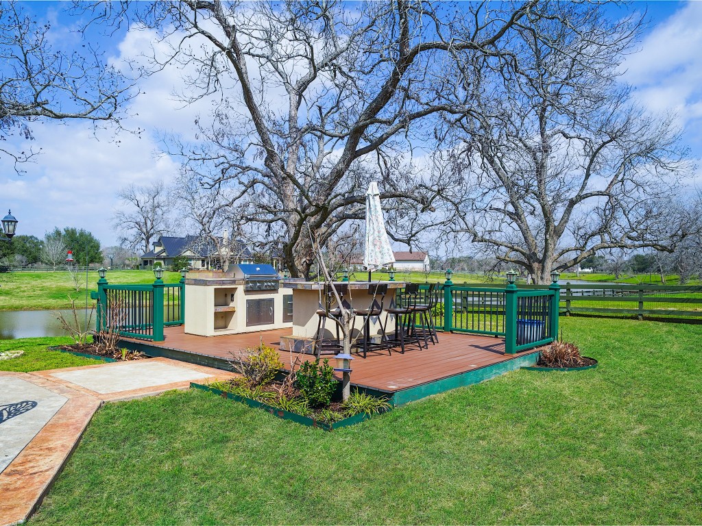32134 Fulbrook Commons Fulshear, TX 77441 - Photo 43 of 49 An outdoor kitchen enhances the entertaining experience, allowing gatherings to flow effortlessly from poolside afternoons to sunset dinners under the open sky.