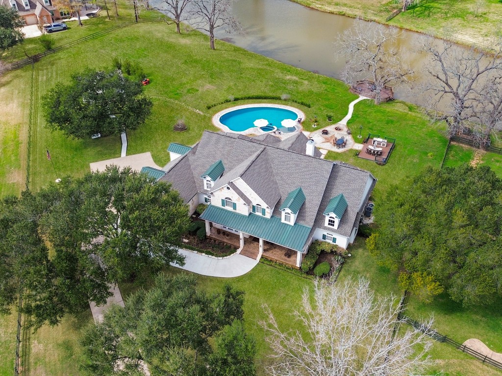 32134 Fulbrook Commons Fulshear, TX 77441 - Photo 49 of 49 A commanding overhead view captures the home’s architectural elegance, expansive roofline (replaced in 2020), gated approach, and seamless integration of indoor luxury with resort-style outdoor amenities — all part of over $280,000 in curated enhancements.