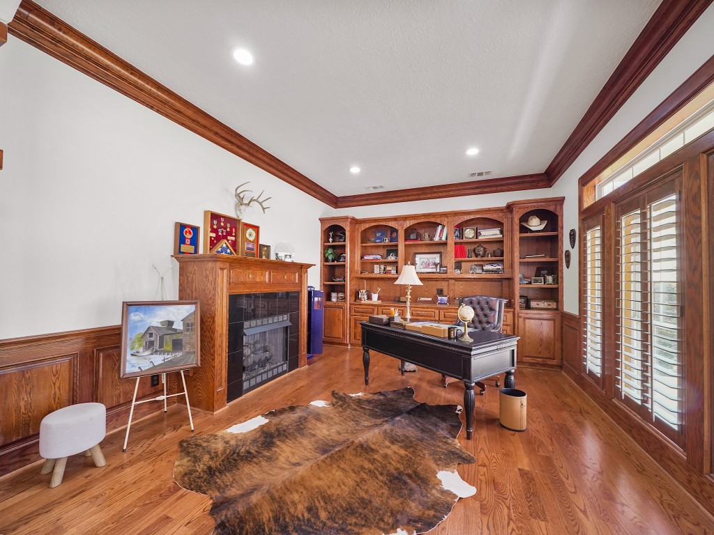 32134 Fulbrook Commons Fulshear, TX 77441 - Photo 7 of 49 A richly appointed study just off the entry features custom built-ins and a fireplace, creating a distinguished workspace or library retreat with warmth and character.