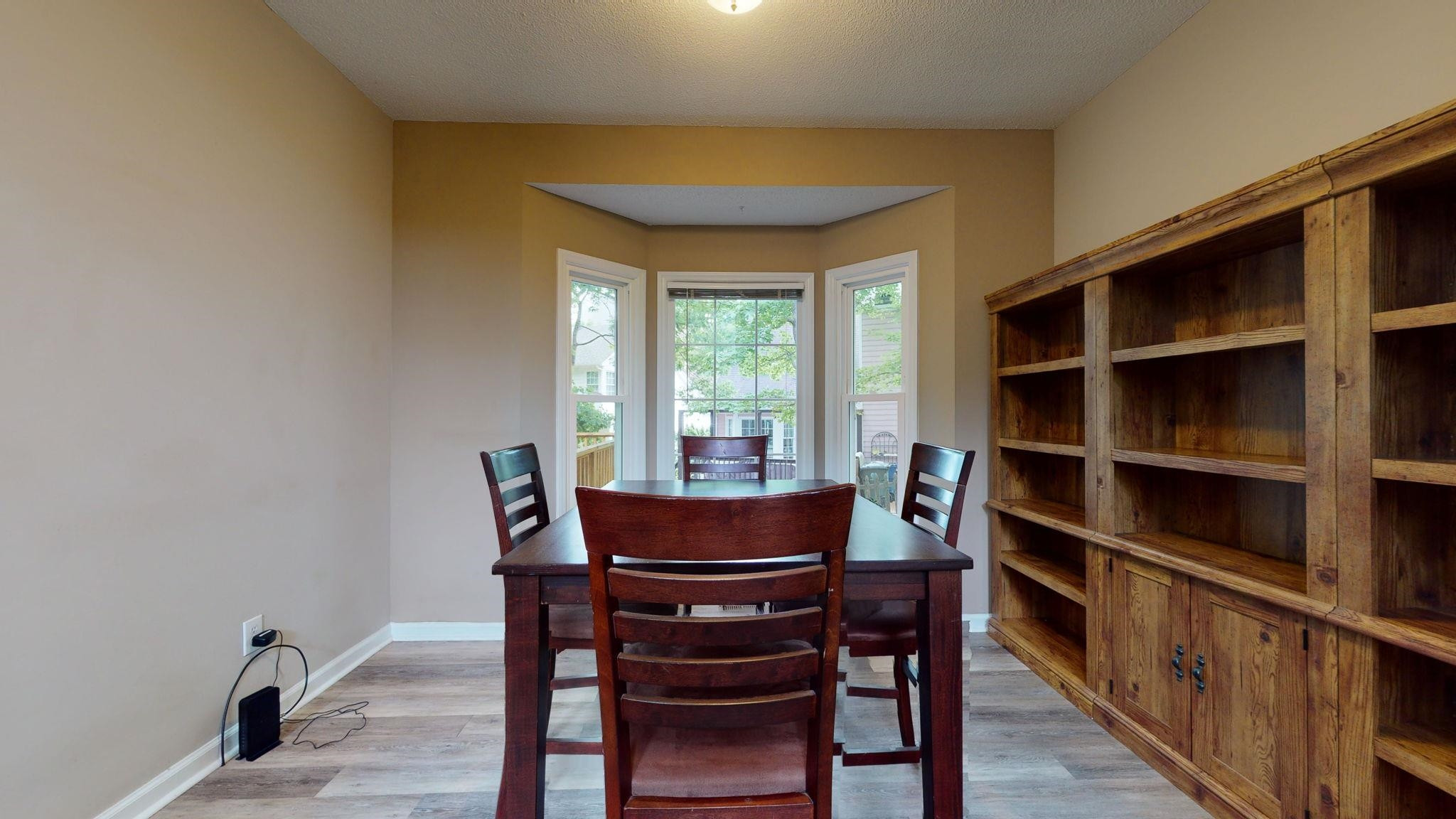 12205 Harcourt Drive Raleigh, NC 27613 - Photo 12 of 35 The dining area overlooks the wooded back yard