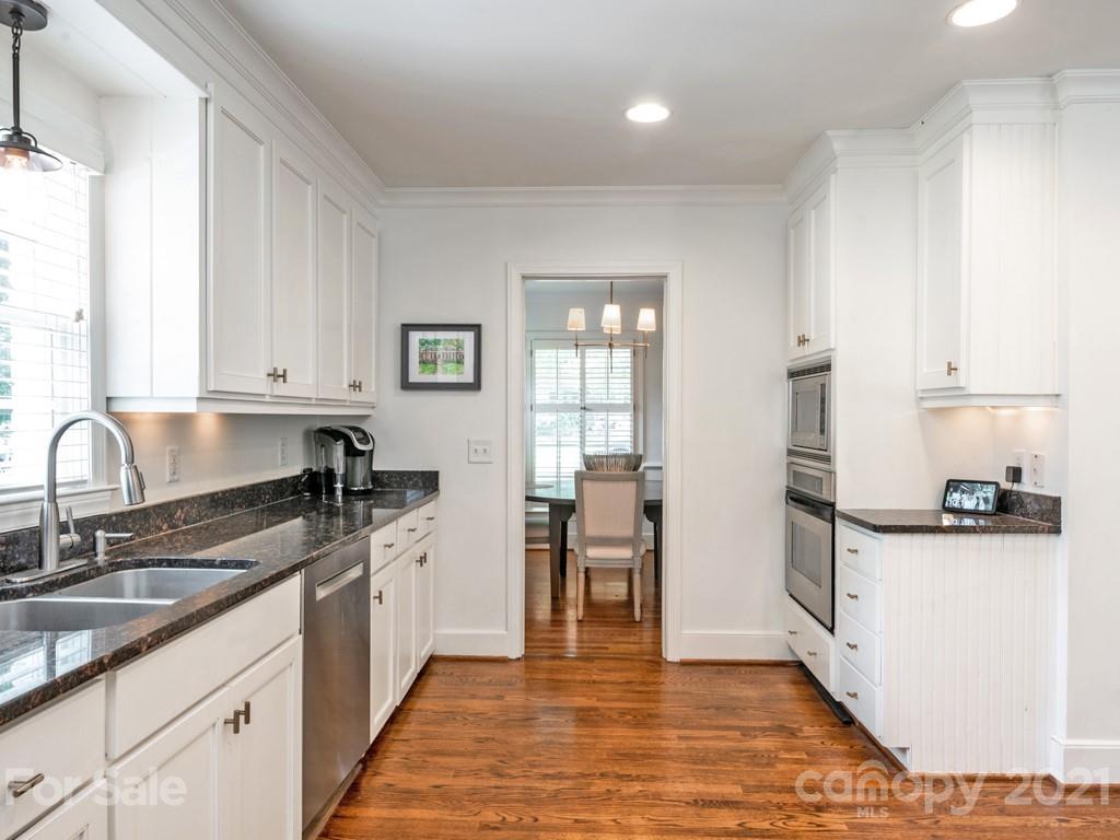 1315 Ferncliff Road Charlotte, NC 28211 - Photo 11 of 44 a kitchen with granite countertop a sink stove and cabinets