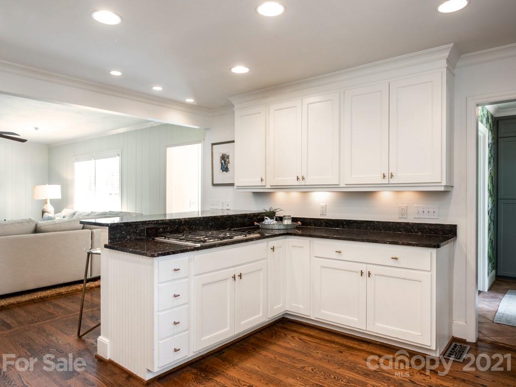 1315 Ferncliff Road Charlotte, NC 28211 - Photo 12 of 44 a kitchen with granite countertop white cabinets and white appliances