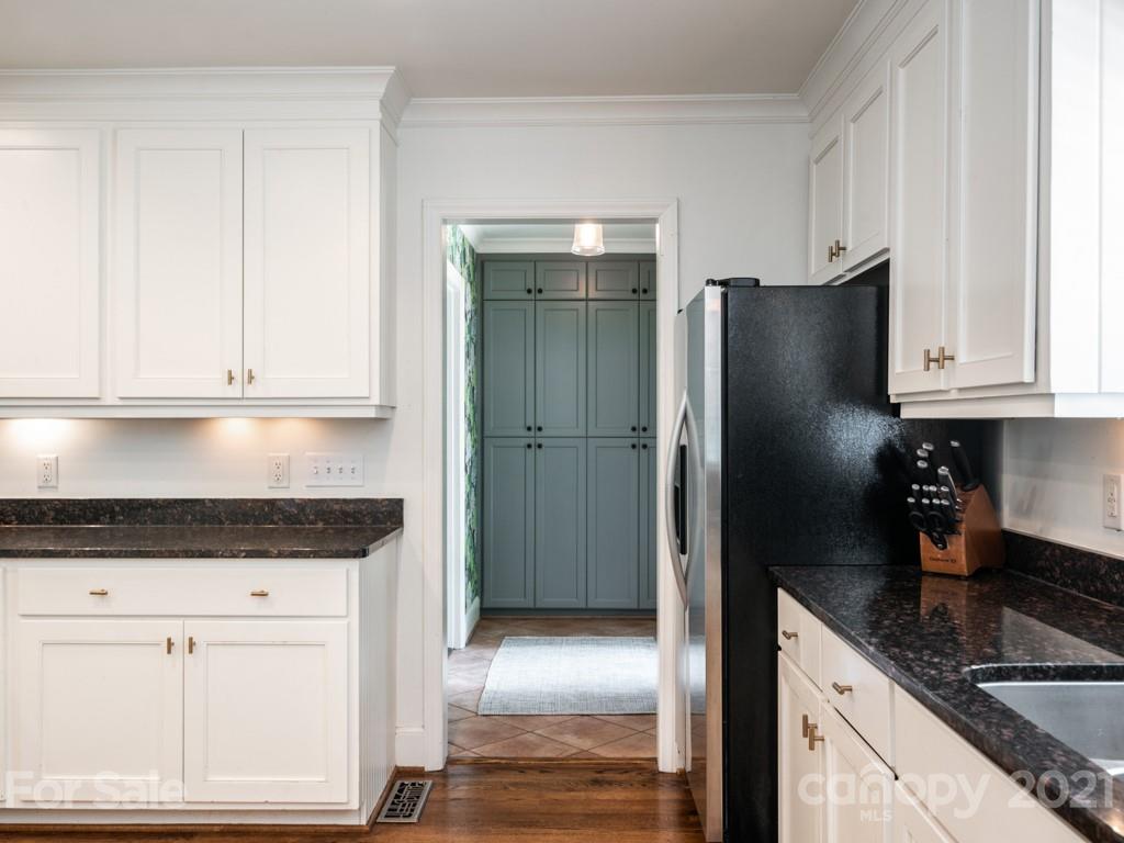 1315 Ferncliff Road Charlotte, NC 28211 - Photo 14 of 44 a kitchen with granite countertop white cabinets and stainless steel appliances