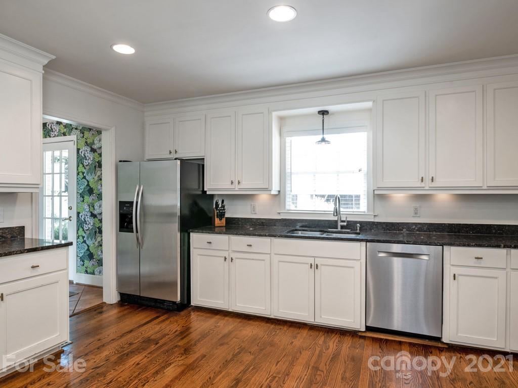 1315 Ferncliff Road Charlotte, NC 28211 - Photo 15 of 44 a kitchen with granite countertop white cabinets white appliances a sink and a window
