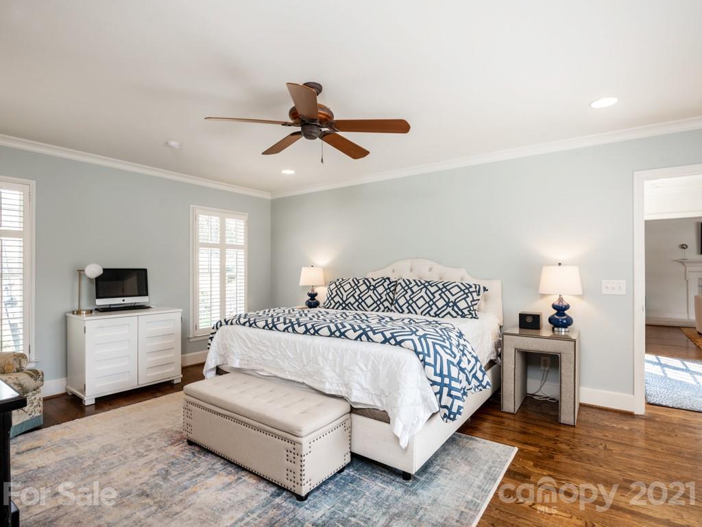 1315 Ferncliff Road Charlotte, NC 28211 - Photo 24 of 44 a bedroom with a bed a couch and a flat tv screen on the dresser