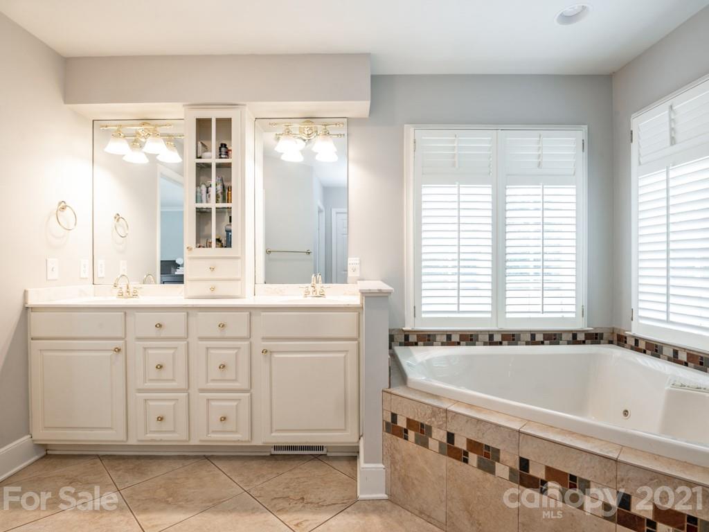 1315 Ferncliff Road Charlotte, NC 28211 - Photo 26 of 44 a spacious bathroom with a tub sink and mirror