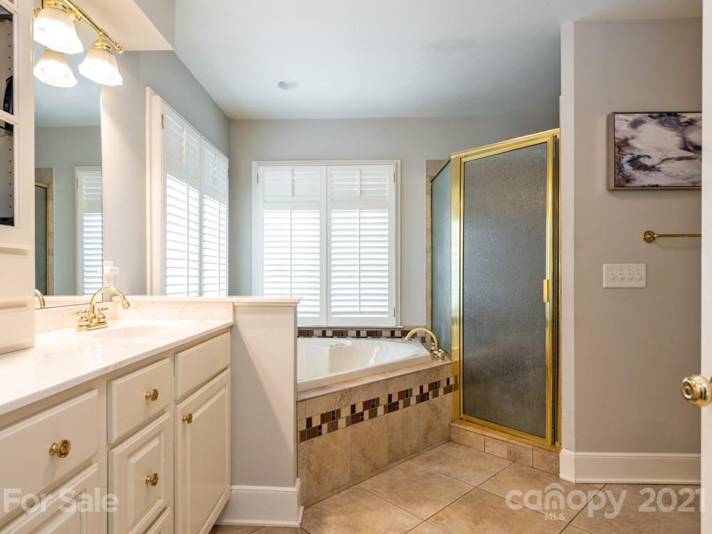 1315 Ferncliff Road Charlotte, NC 28211 - Photo 27 of 44 a spacious bathroom with double vanity and a bathtub
