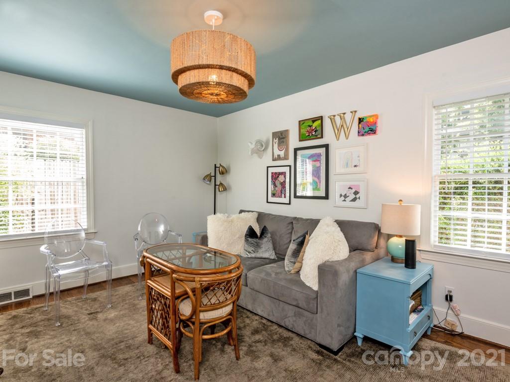 1315 Ferncliff Road Charlotte, NC 28211 - Photo 31 of 44 a living room with furniture a chandelier and a large window