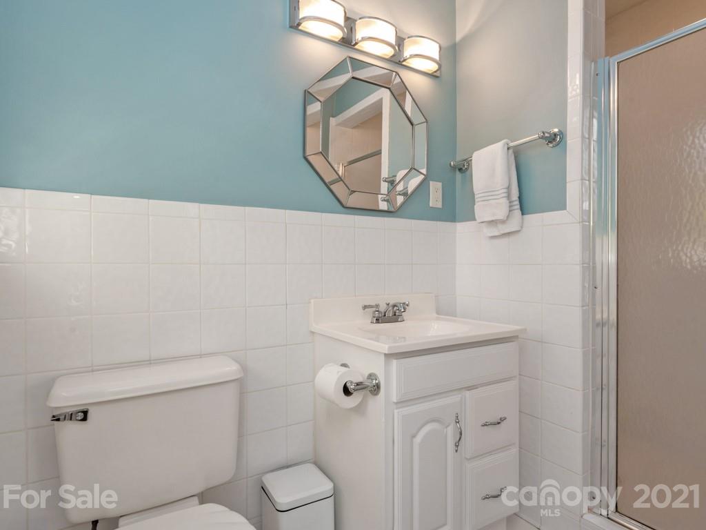 1315 Ferncliff Road Charlotte, NC 28211 - Photo 33 of 44 a bathroom with a sink a toilet and mirror
