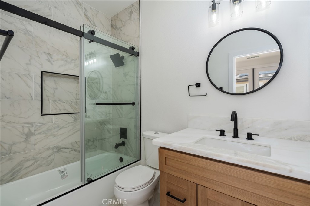 17741 Laurel Grove Road Riverside, CA 92504 - Photo 11 of 62 a bathroom with a sink a toilet and a mirror