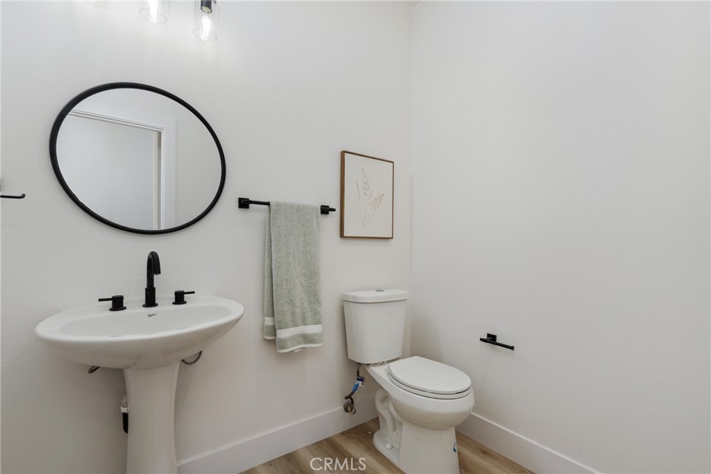 17741 Laurel Grove Road Riverside, CA 92504 - Photo 14 of 62 a bathroom with a toilet sink and mirror