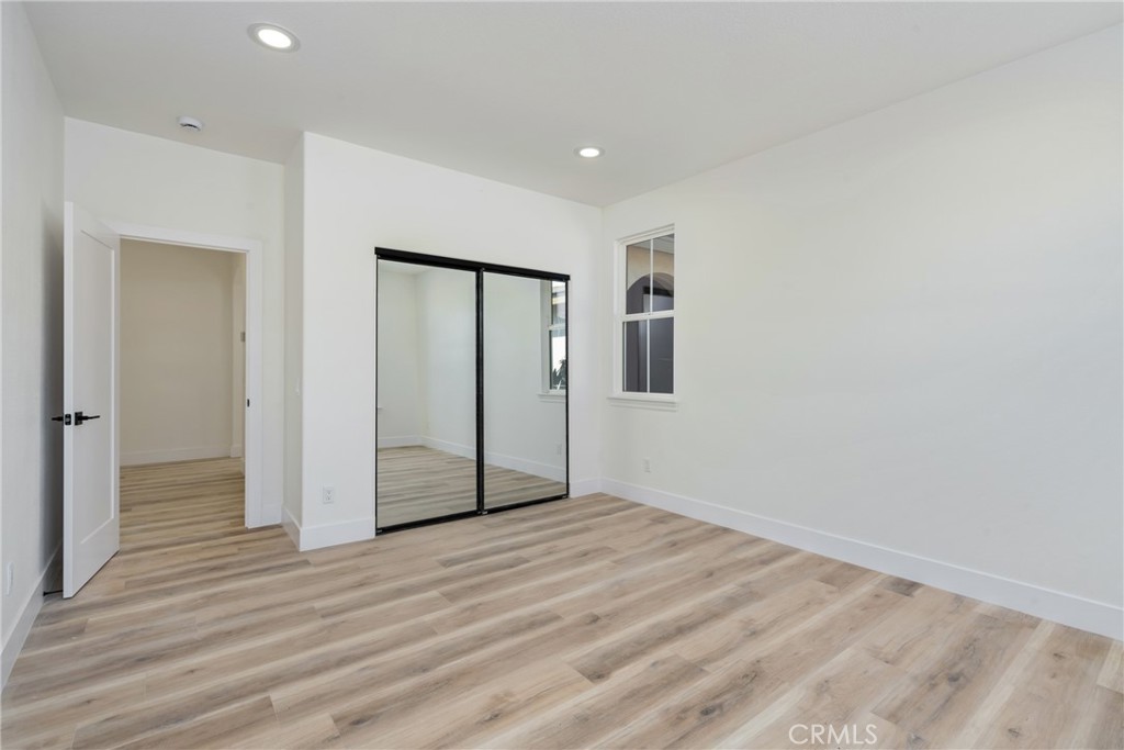 17741 Laurel Grove Road Riverside, CA 92504 - Photo 16 of 62 a view of empty room with wooden floor