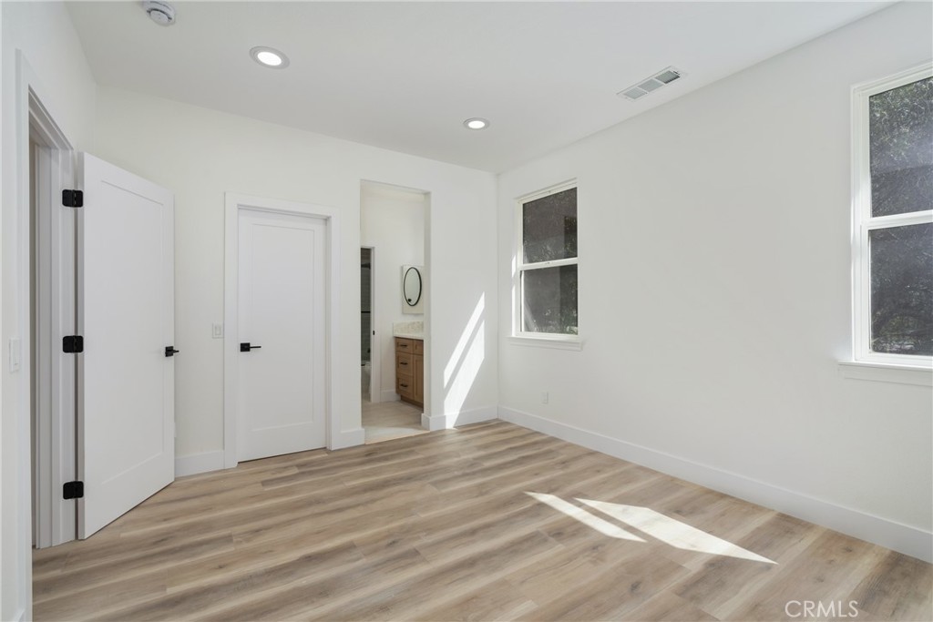 17741 Laurel Grove Road Riverside, CA 92504 - Photo 22 of 62 a view of empty room with wooden floor and window