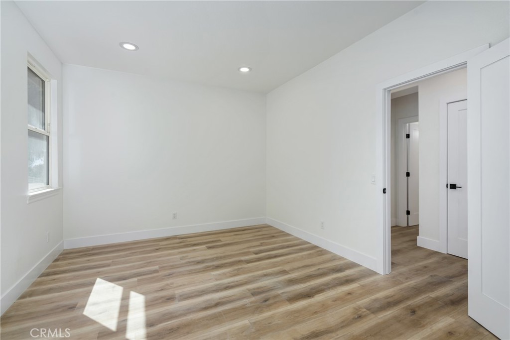 17741 Laurel Grove Road Riverside, CA 92504 - Photo 23 of 62 a view of a room with wooden floor and white walls