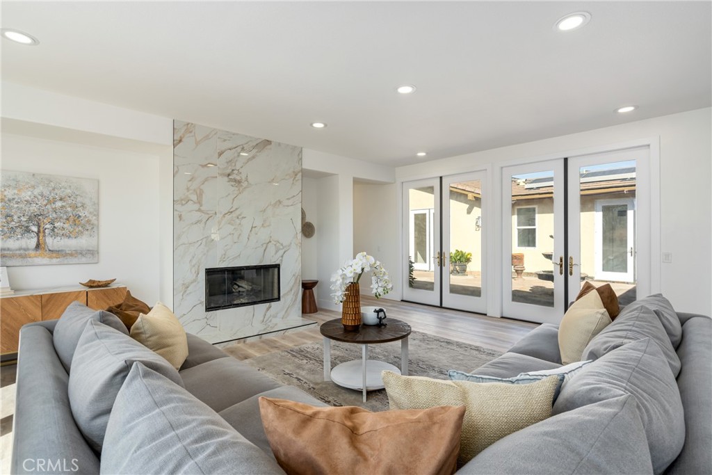 17741 Laurel Grove Road Riverside, CA 92504 - Photo 39 of 62 a living room with furniture a fireplace and a large window