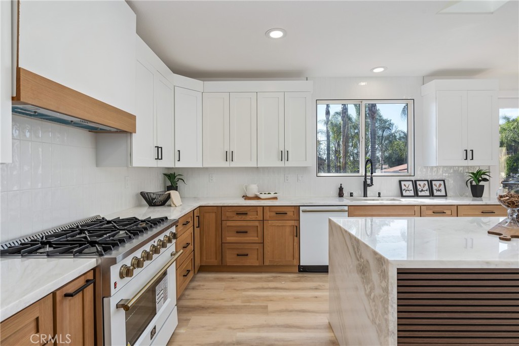 17741 Laurel Grove Road Riverside, CA 92504 - Photo 44 of 62 a large kitchen with stainless steel appliances granite countertop a stove and a sink