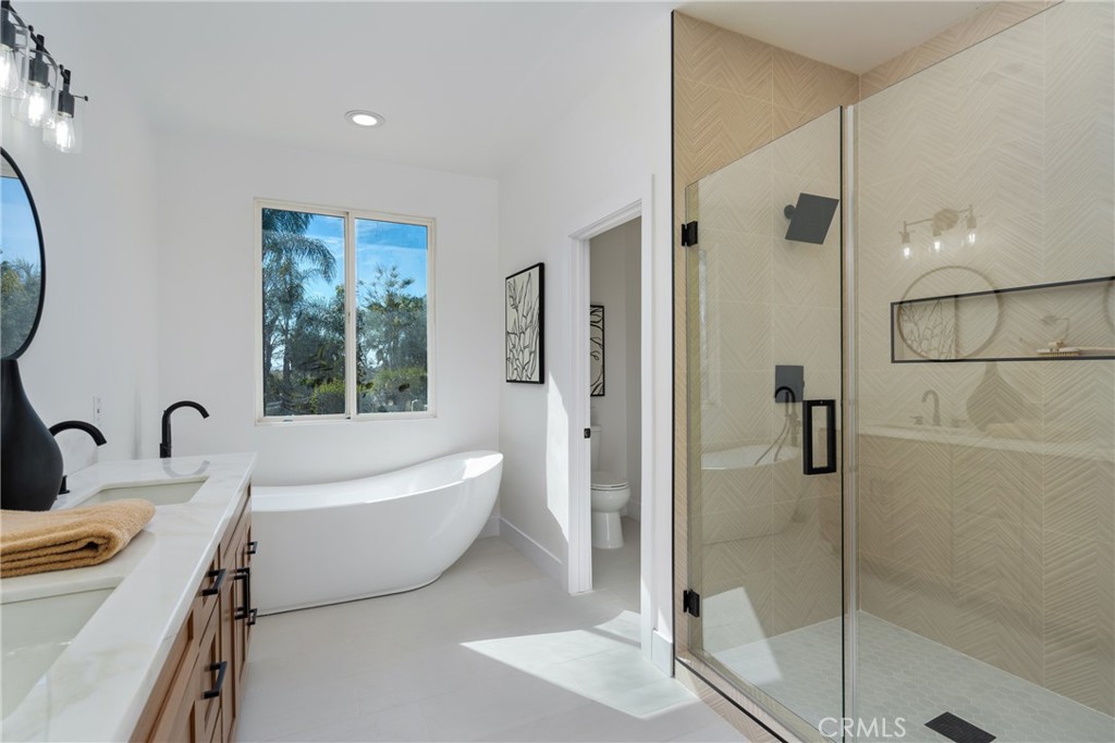 17741 Laurel Grove Road Riverside, CA 92504 - Photo 52 of 62 a bathroom with a tub sink and mirror