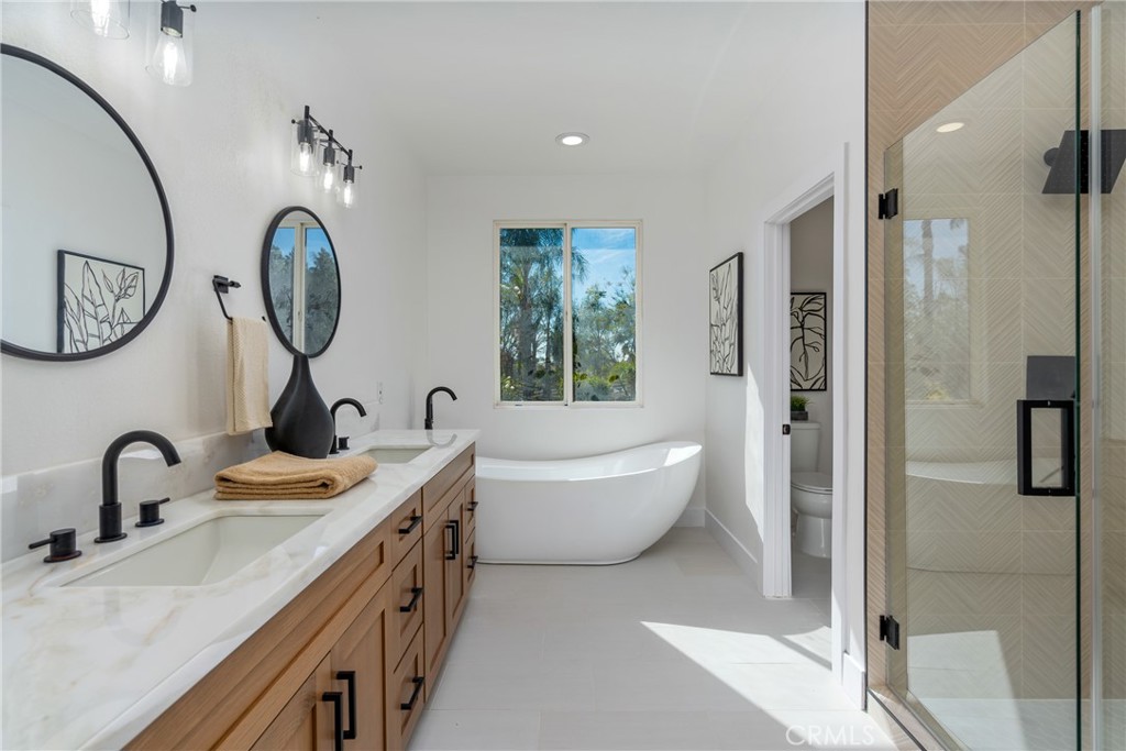 17741 Laurel Grove Road Riverside, CA 92504 - Photo 53 of 62 a bathroom with a double vanity sink and a mirror