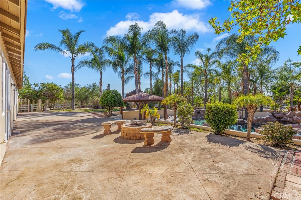 17741 Laurel Grove Road Riverside, CA 92504 - Photo 58 of 62 a view of a patio with a table and chairs under an umbrella