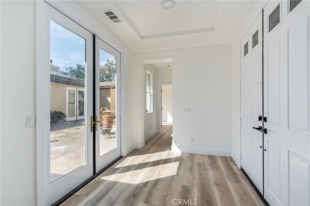 17741 Laurel Grove Road Riverside, CA 92504 - Photo 7 of 62 a view of a hallway with wooden floor and a bathroom