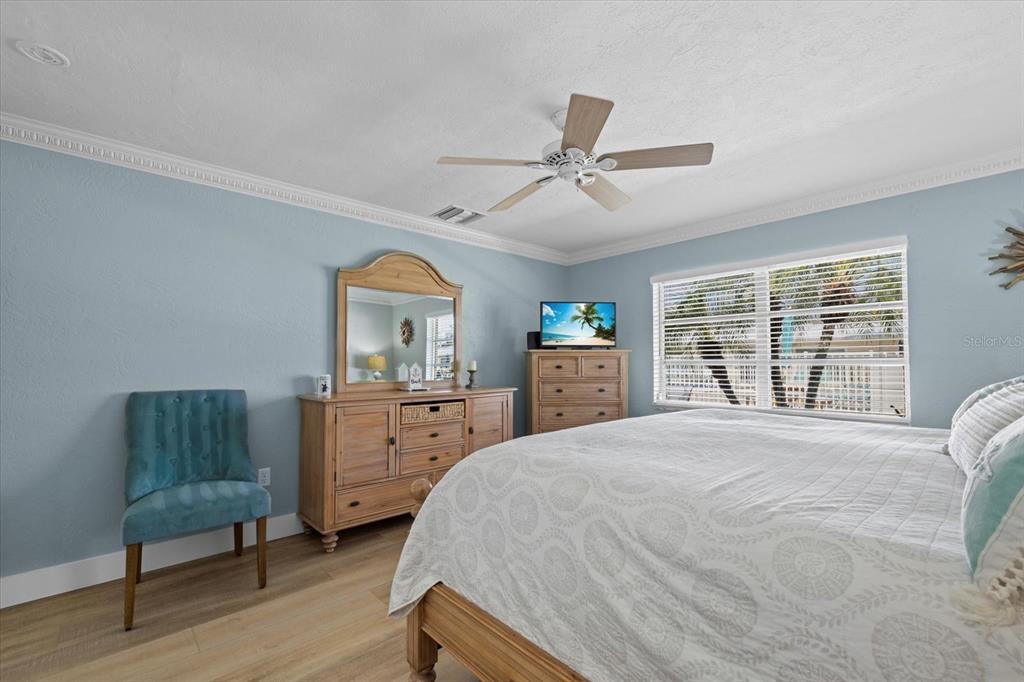 5830 Midnight Pass Road, Unit 52 Sarasota, FL 34242 - Photo 12 of 32 a bedroom with a bed and a dresser next to a window