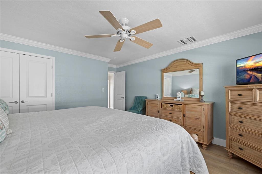 5830 Midnight Pass Road, Unit 52 Sarasota, FL 34242 - Photo 14 of 32 a bedroom with a bed and a dresser