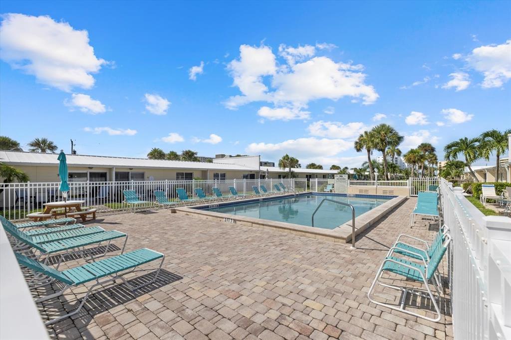 5830 Midnight Pass Road, Unit 52 Sarasota, FL 34242 - Photo 20 of 32 a view of a swimming pool with a lounge chair
