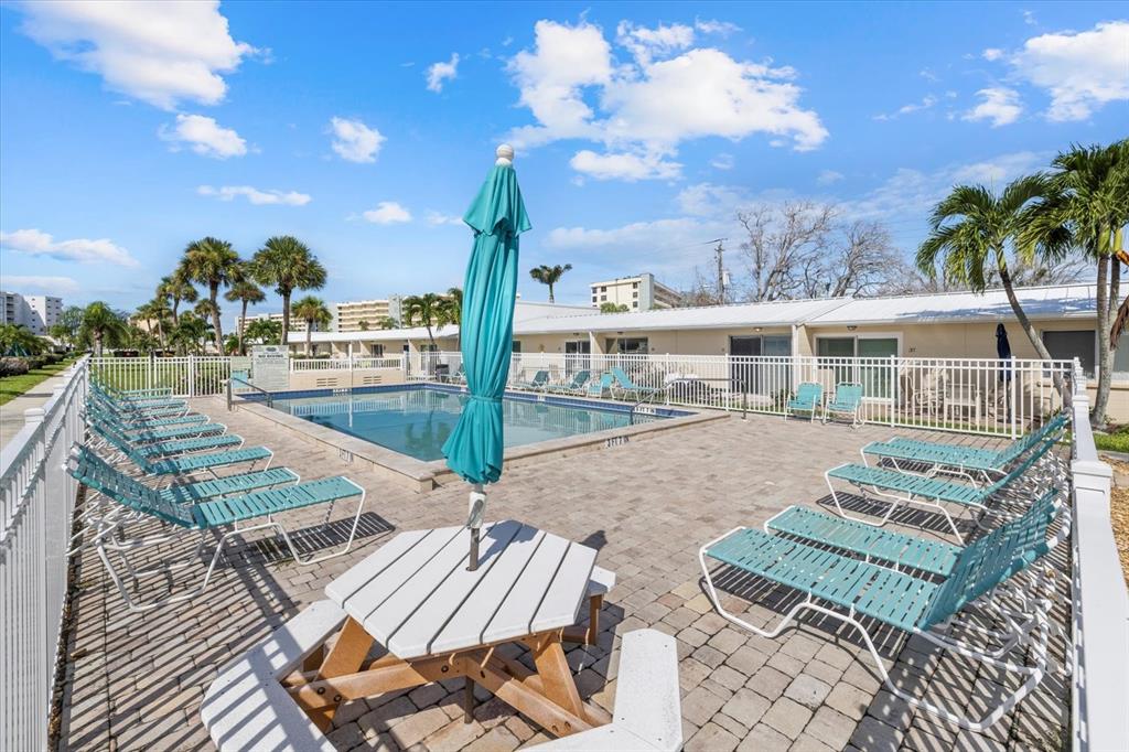 5830 Midnight Pass Road, Unit 52 Sarasota, FL 34242 - Photo 21 of 32 a view of a patio with swimming pool and sitting area