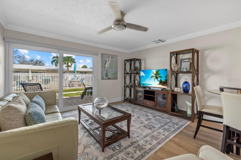 5830 Midnight Pass Road, Unit 52 Sarasota, FL 34242 - Photo 5 of 32 a living room with furniture and a window