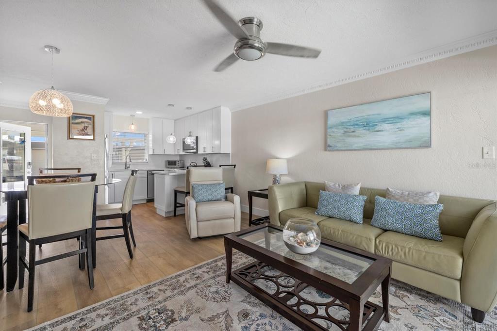 5830 Midnight Pass Road, Unit 52 Sarasota, FL 34242 - Photo 6 of 32 a living room with furniture kitchen view and a dining table