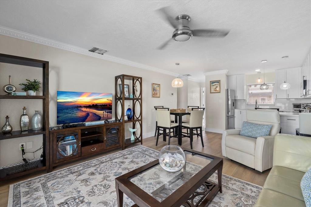 5830 Midnight Pass Road, Unit 52 Sarasota, FL 34242 - Photo 7 of 32 a living room with furniture kitchen view and a table
