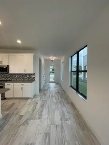 a view of kitchen with refrigerator and window
