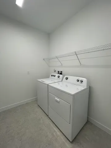 an empty room with a window and a ceiling fan